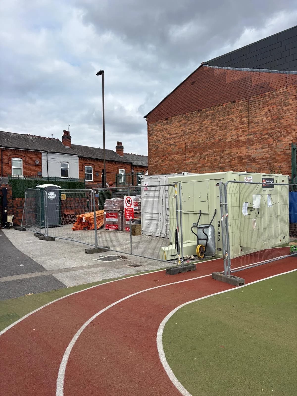 School site with welfare cabins during a roofing project