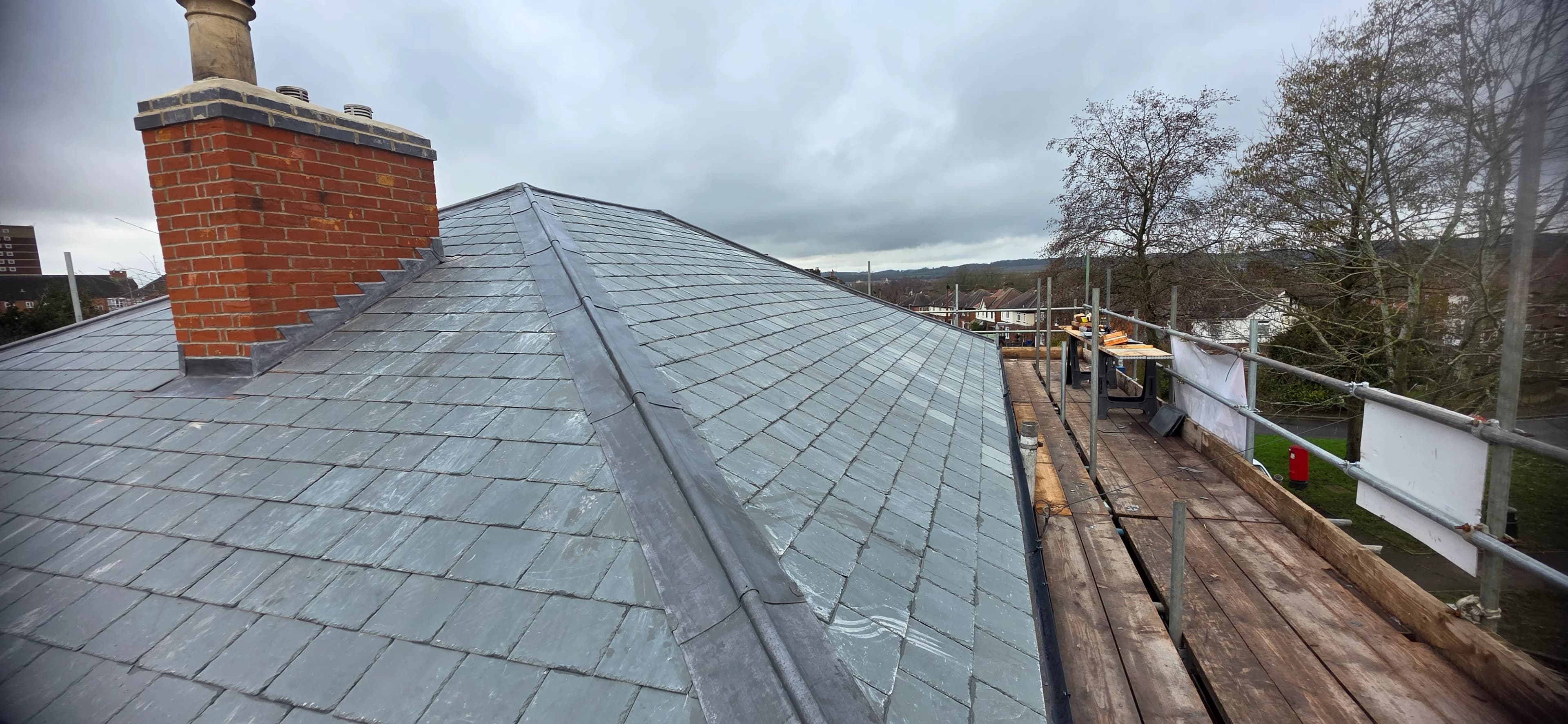 Slate roof with brick chimney after a full re-roof