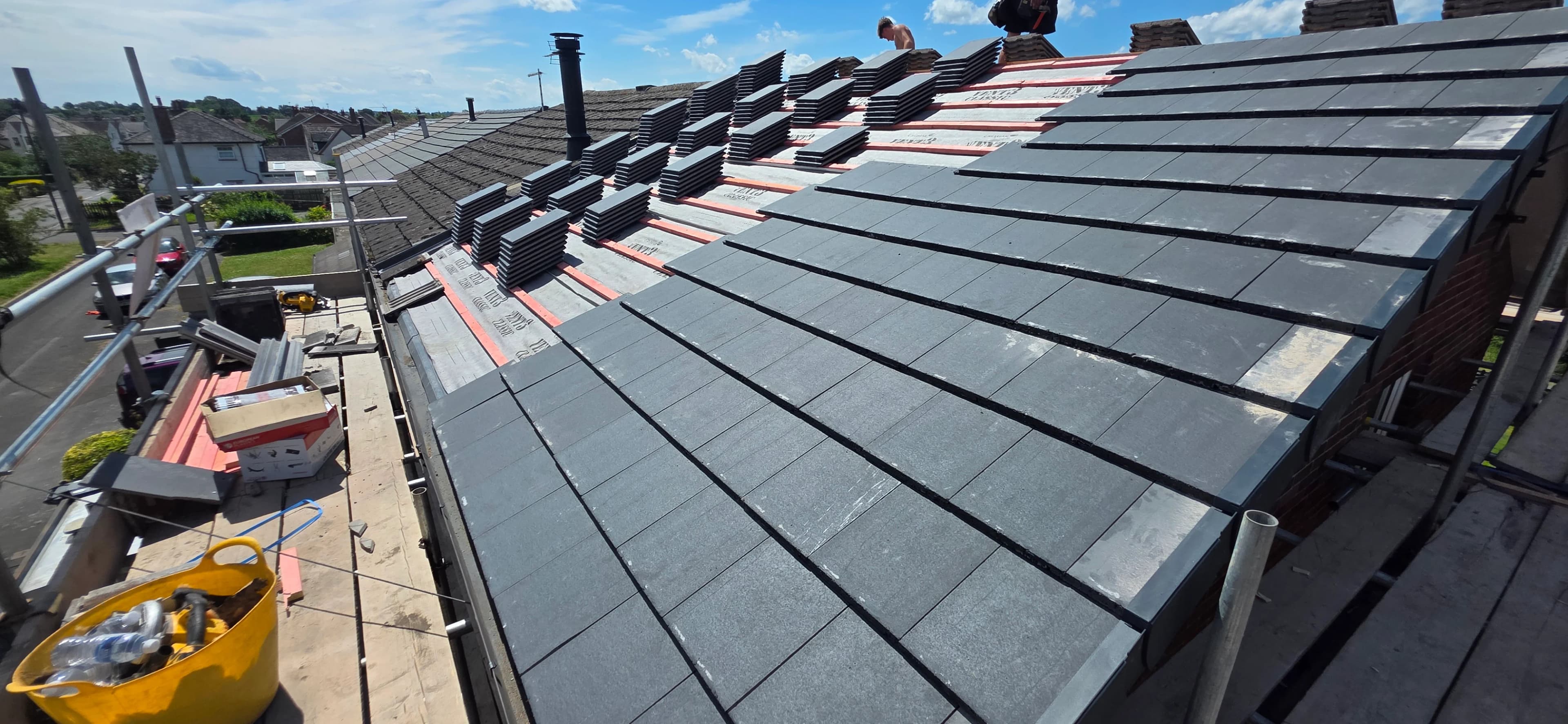 New grey tiled roof with a street view behind