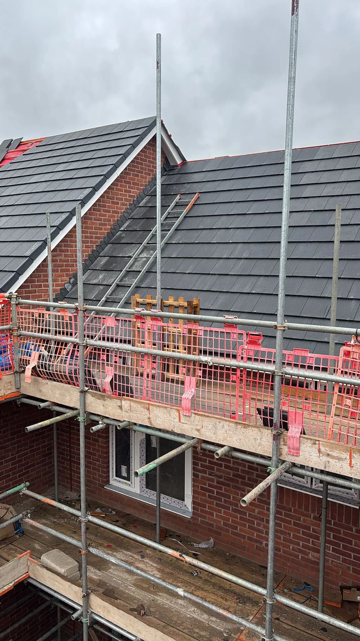 Slate roof covering in progress on a detached property