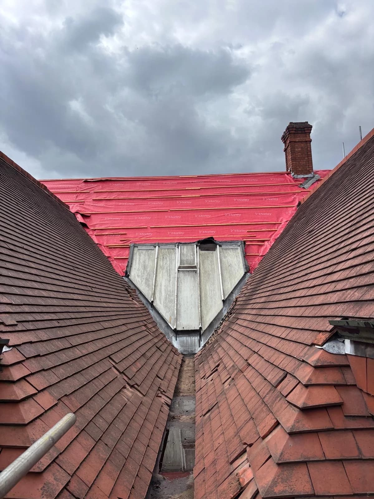 Lead valley and flashing detail between tiled roof slopes