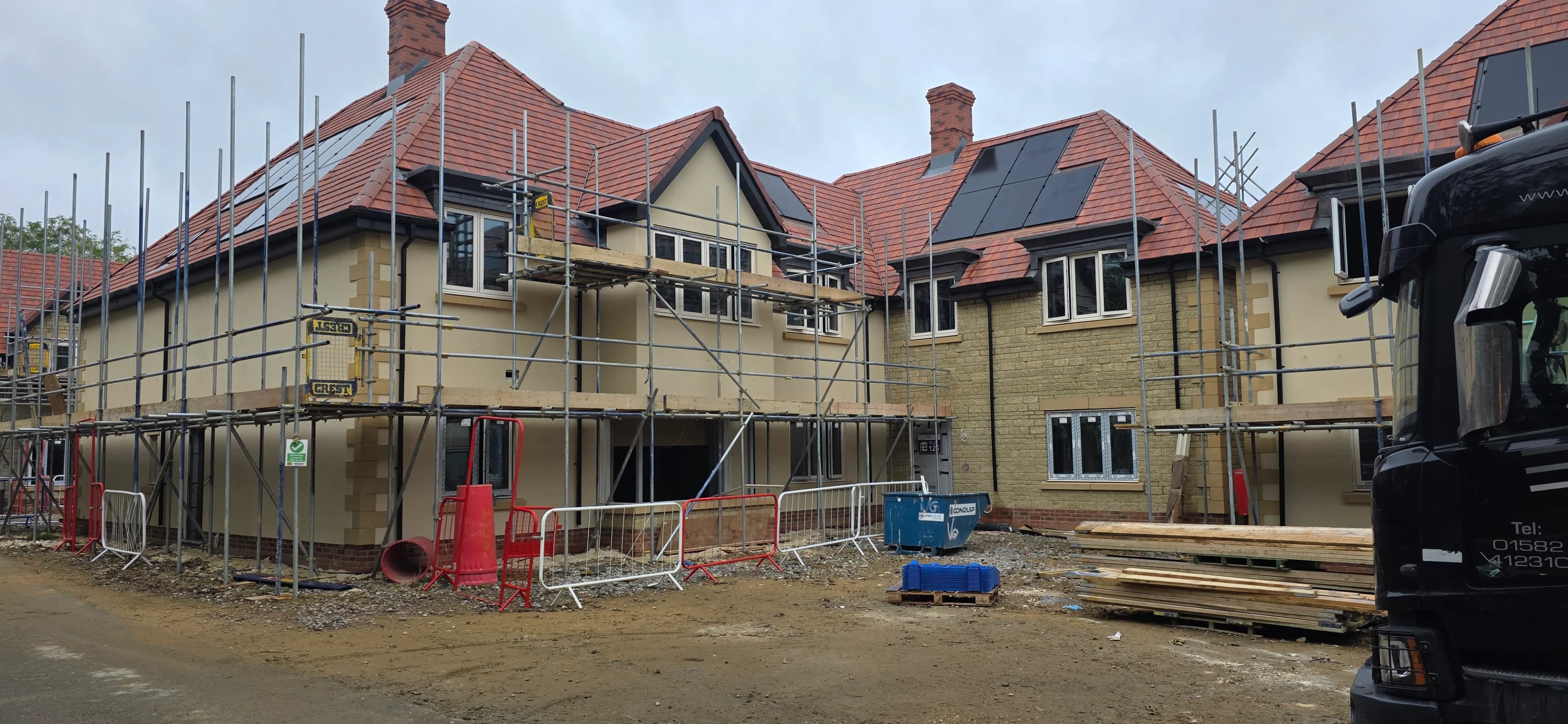 New-build housing development with tiled roofs and scaffolding