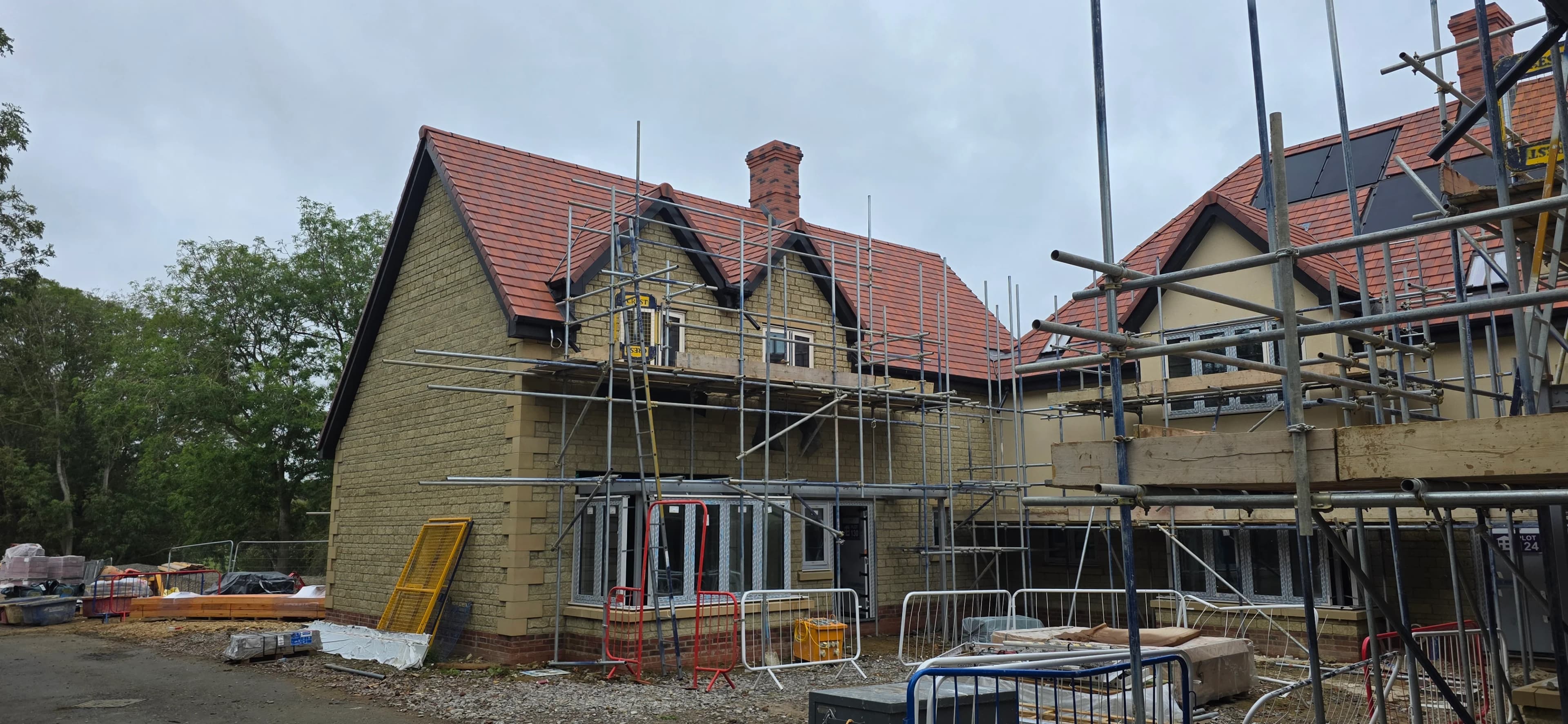 Rows of new-build roofs under construction with scaffolding