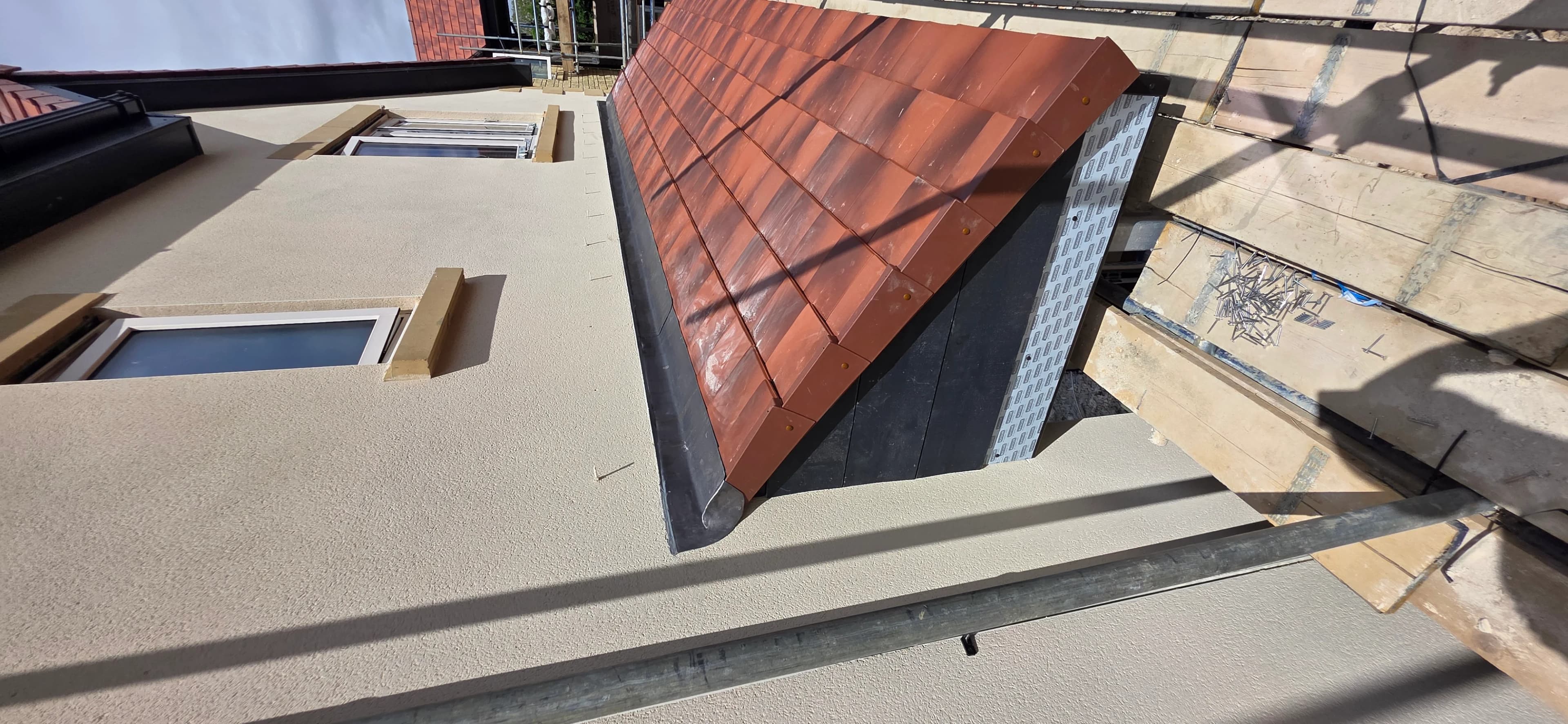 Red clay tile detail along a flat roof edge